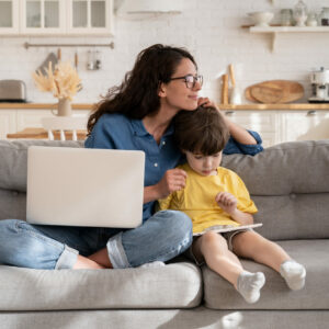 Woman caring for her child while participating in an online Nurtured call