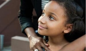 Young girl looking at wistfully across the camera angle.