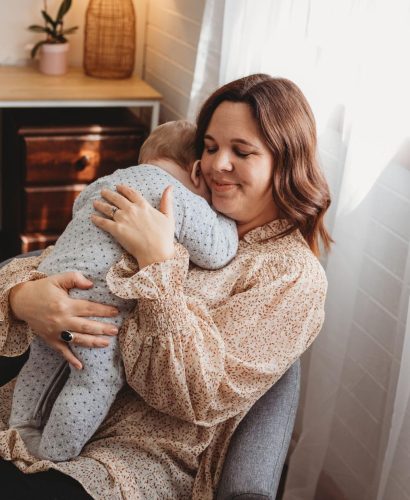 Katie Parker nursing a baby during a perinatal counselling session.