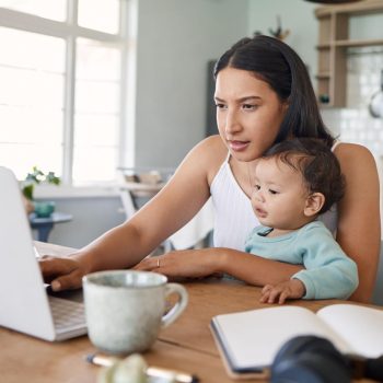 Mum juggling her baby and new business while participating in a group call as part of the Nurtured program.